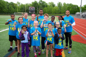 Winners of the EC34 5K show off their medals and trophies following the May 21 event.