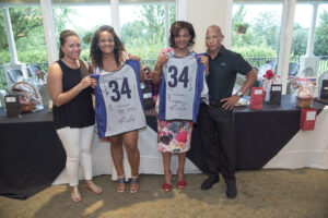 Billy Atkins presented No. 34 jerseys to Erin and Forrestine Coombs.
